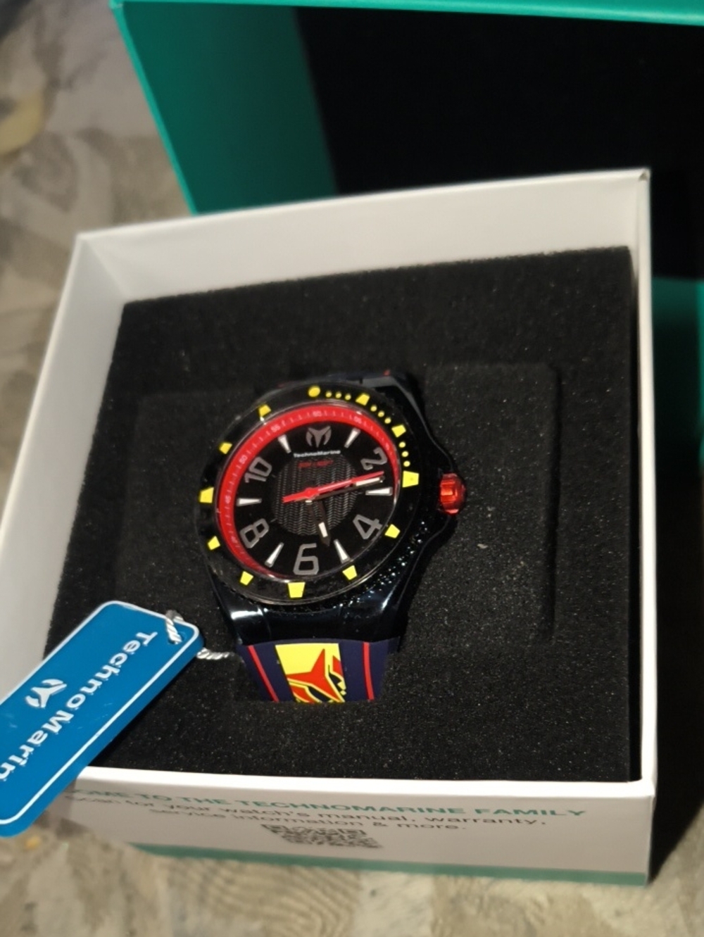 Technomarine Black Watch with Red & Yellow Accents Still Has Plastic